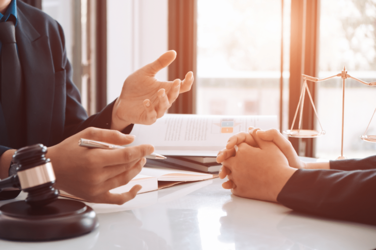 A lawyer explains legal options to a client during a consultation. The scene features a gavel, legal scales, and documents.