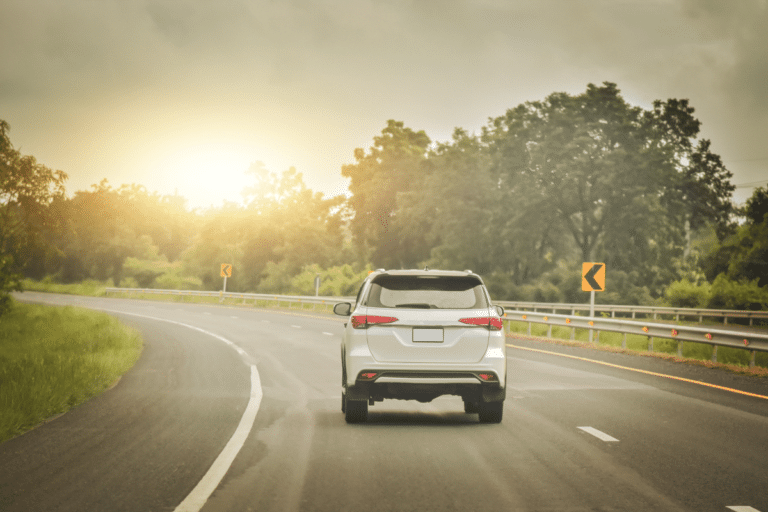 silver SUV driving down on an empty land