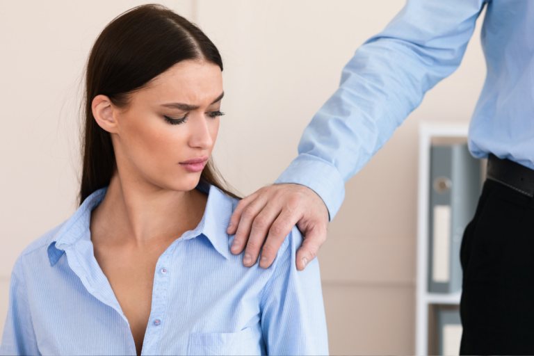 woman looking uncomfortable as man touches her shoulder