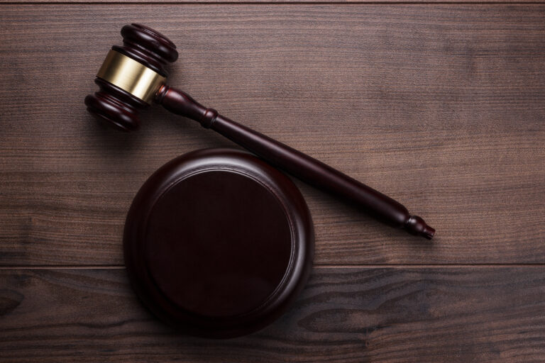 Judge’s wooden gavel and sound block on a wooden table