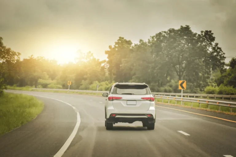 silver SUV driving down on an empty land