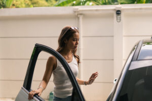 Young woman stepping out of an Uber looking hesitant