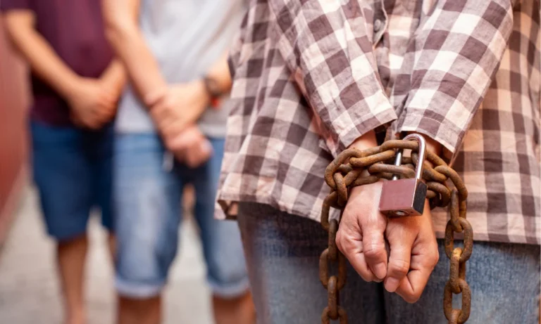 a lady hand chained and locked with padlock