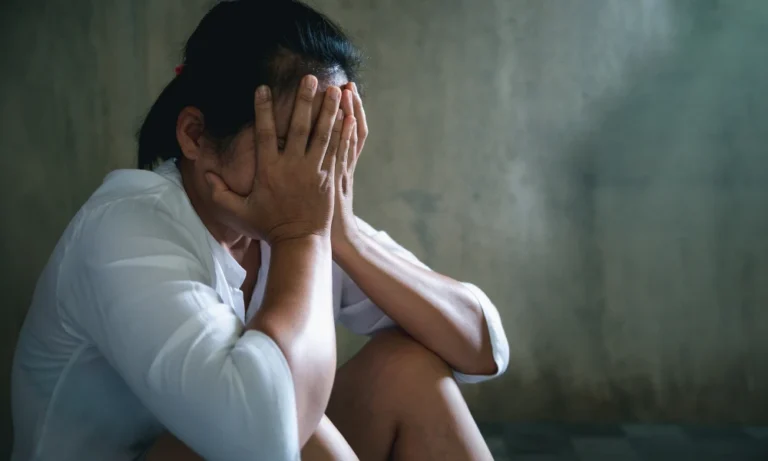 a lady sitting on the floor and in agony