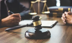 a gavel on the table as attorney talks to a client