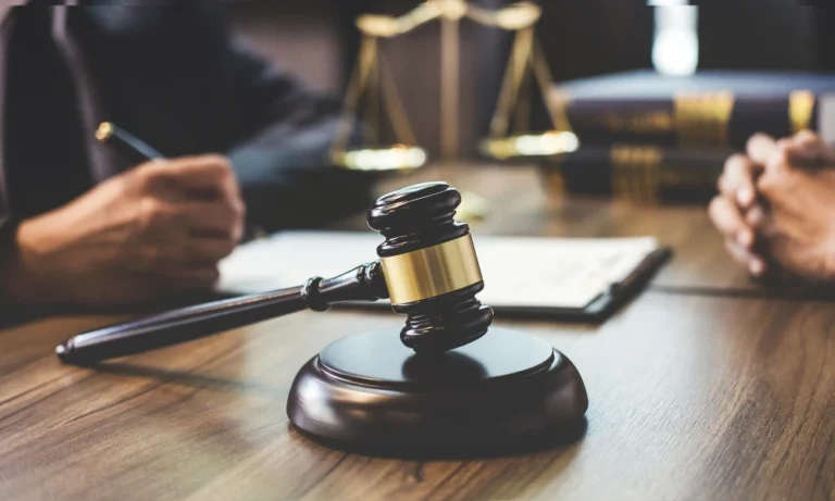 a gavel on the table as attorney talks to a client