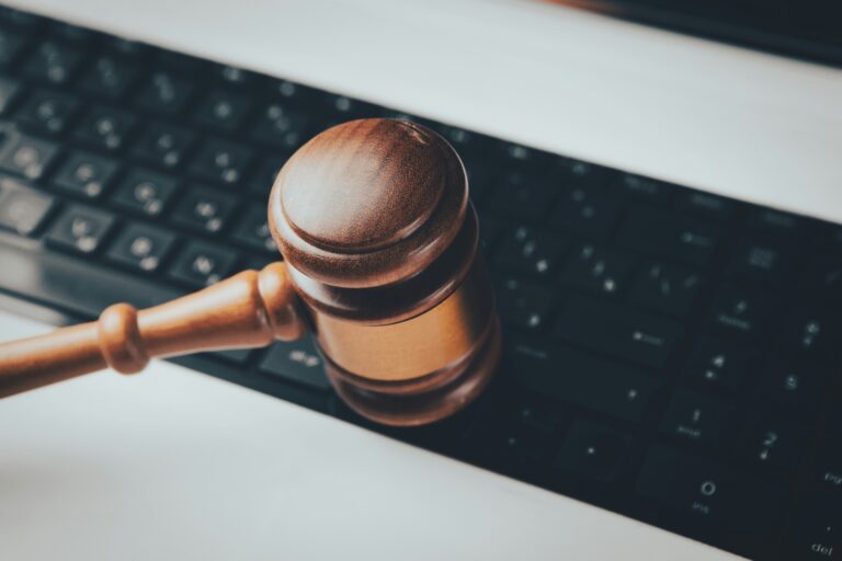 Close up photo of a gavel over a keyboard