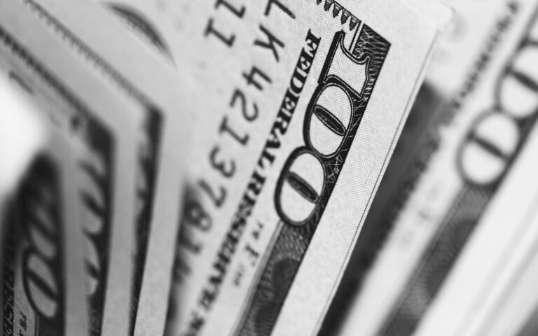 Close-up photograph of $100 bills in $100m settlement for sexual abuse by Richard Strauss at Ohio State