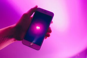Person holding a phone open to the Lyft rideshare app