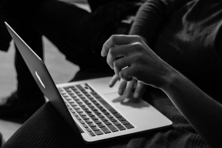 Black and white photo of a parent creating child safe accounts on Roblox on a computer