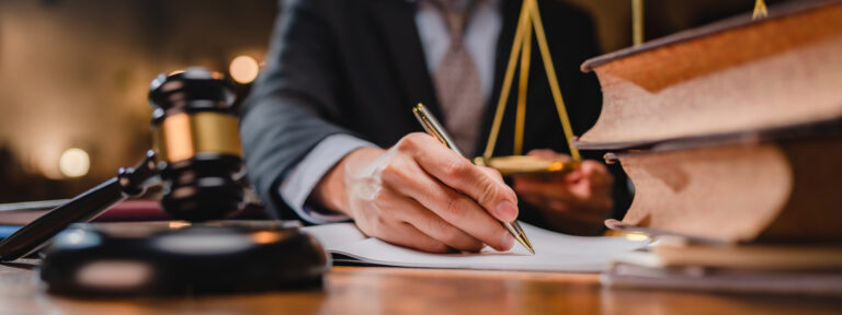 Legal expert reviewing rideshare laws at legal office with computer laptop