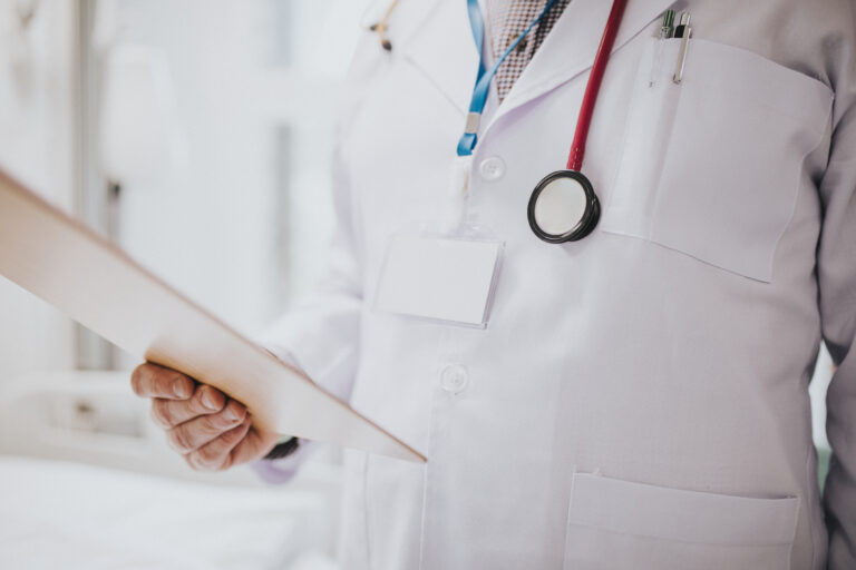 Doctor reading a patients medical chart